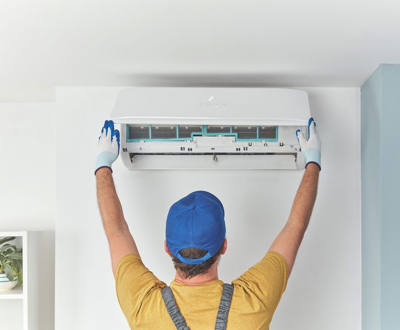 Man Installed New Air Conditioning Unit — Townsville Electrical and Appliance Repairs In Aitkenvale, QLD