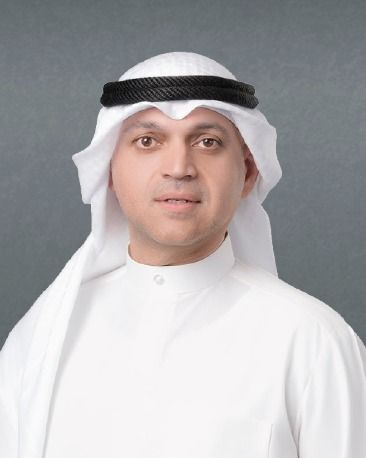 A man in a suit and tie is looking at the camera.