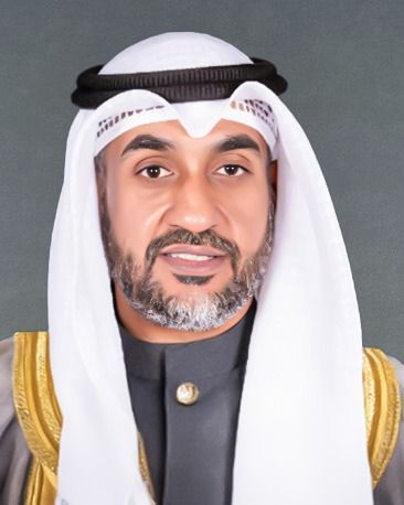 A man wearing glasses and a white scarf around his head