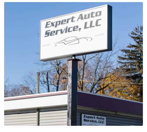 Expert Auto Service, LLC sign on a pole outside a building on a clear day | Expert Auto Service & Licensing