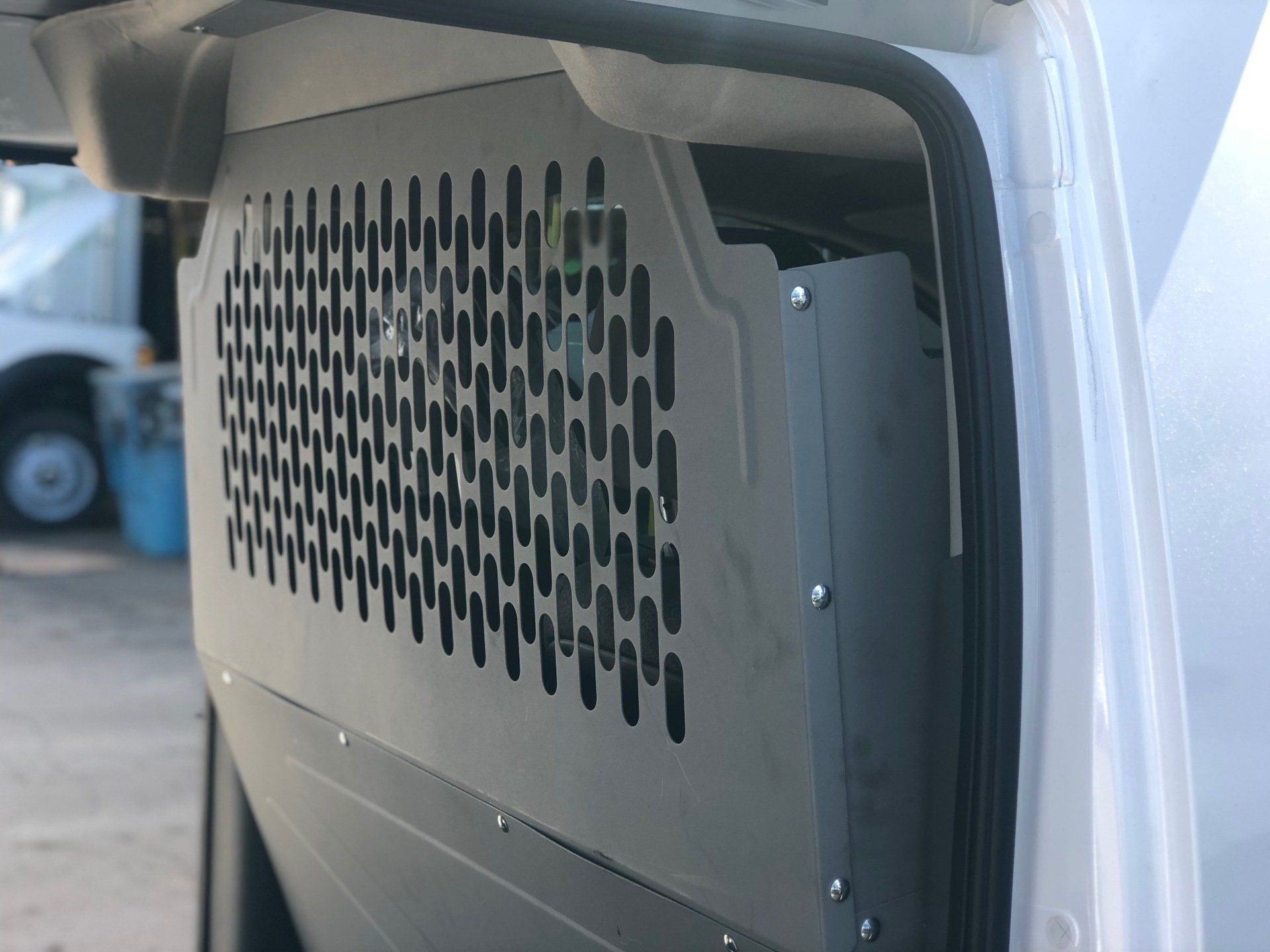 a white van with a cage on the side of it .