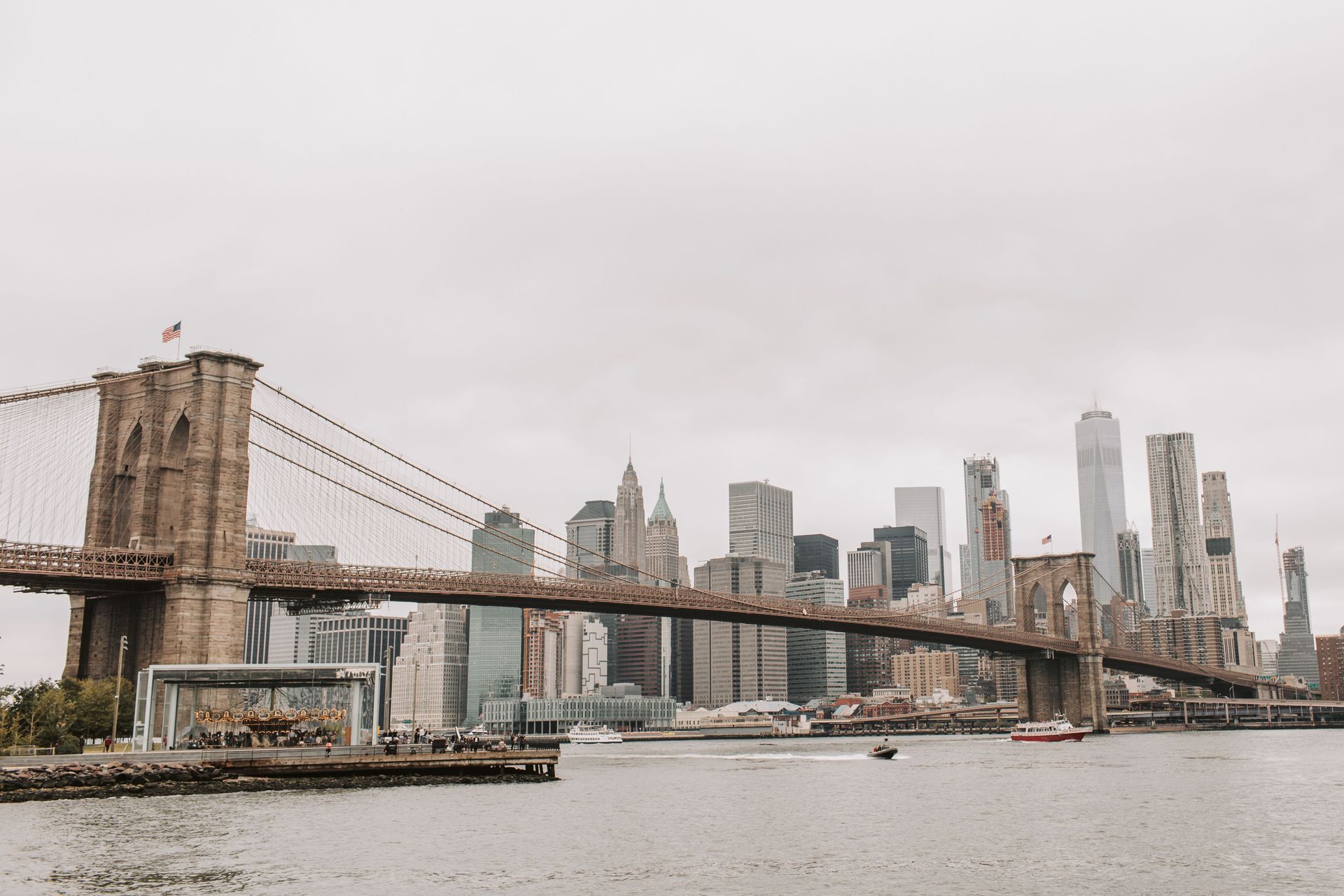 Brooklyn Bridge with Manhattan skyline on a cloudy day over the East River