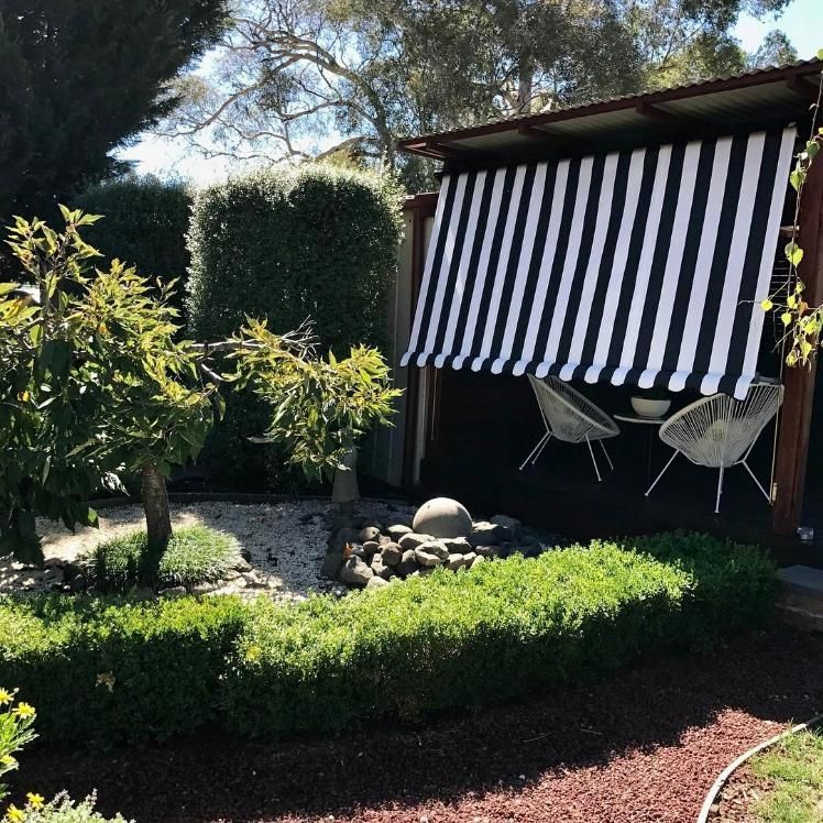 Black And White Striped Awning Over Small Patio With Chairs — JSF Interiors Goulburn in Southern Highlands, NSW