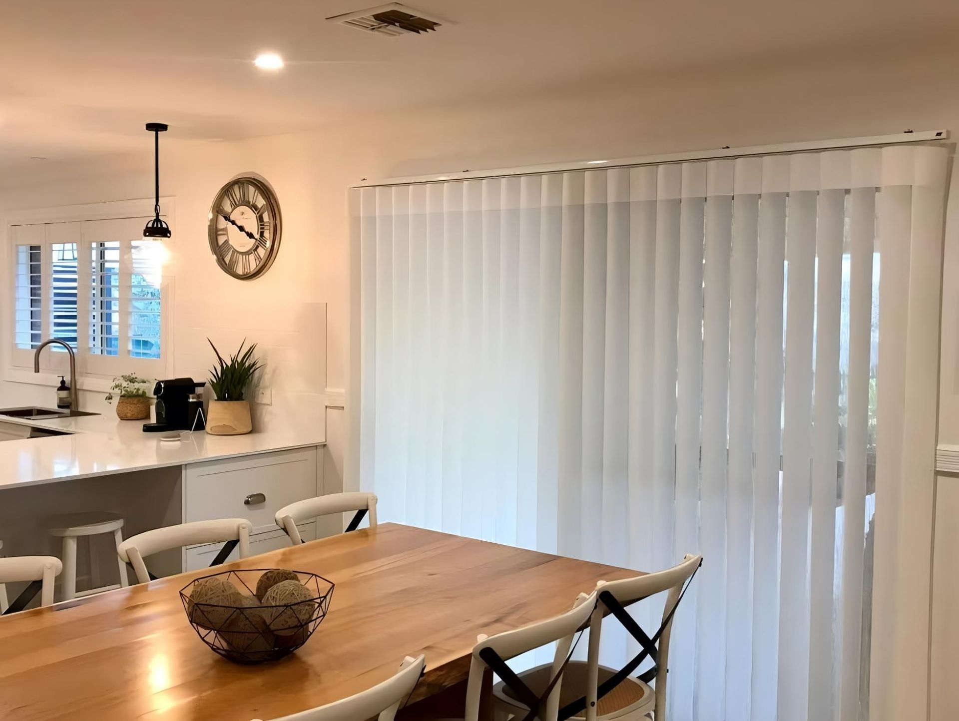 Dining Room With Wood Table And Vertical Blinds — JSF Interiors Goulburn in Goulburn, NSW