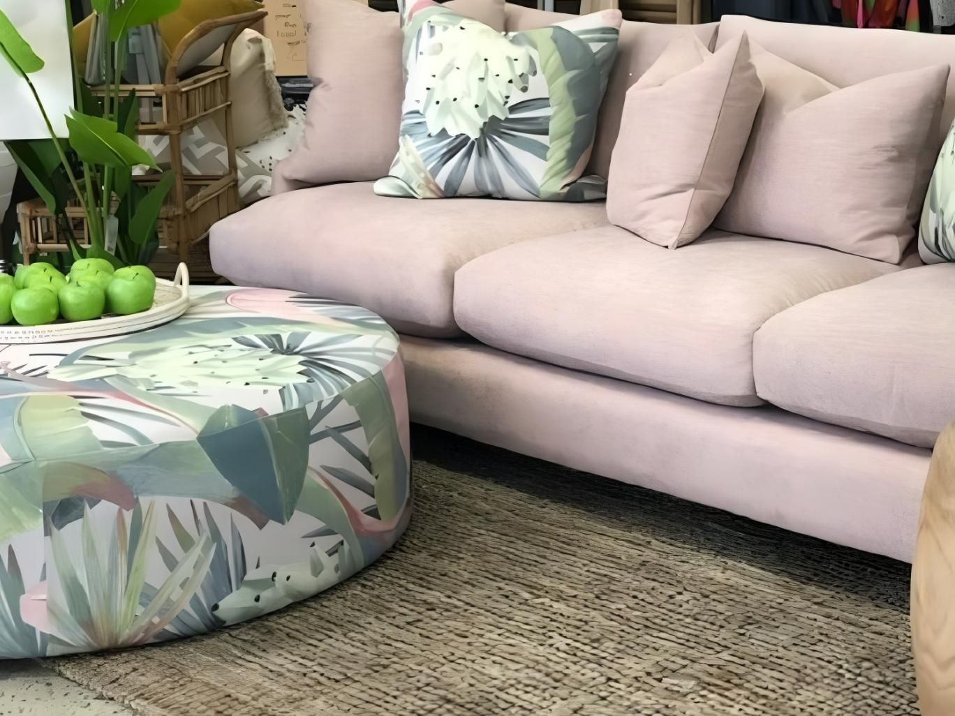 Pink Sofa With Decorative Pillows And Round Ottoman — JSF Interiors Goulburn in Goulburn, NSW