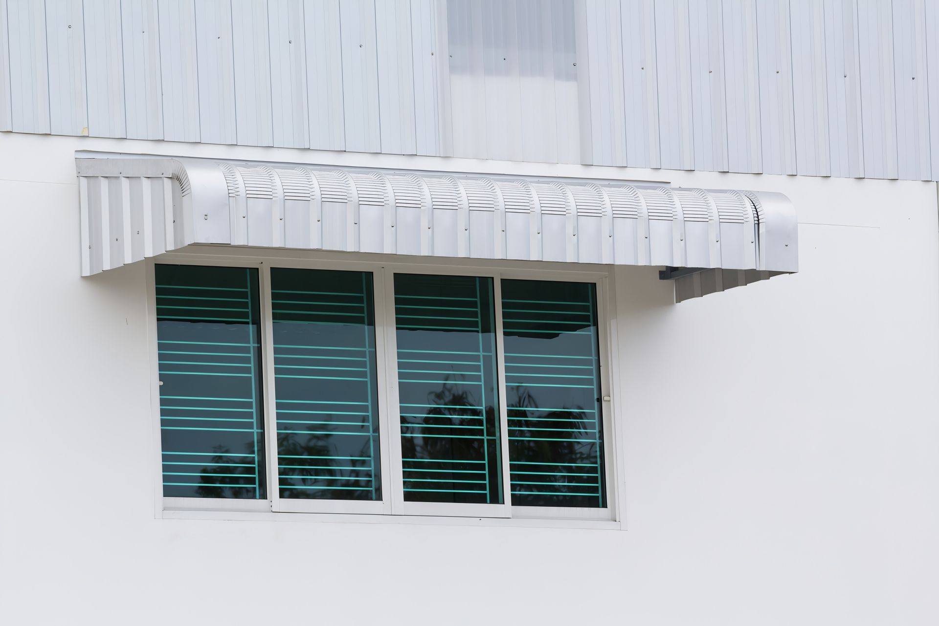 White Building With Metal Awning And Green Tinted Windows — JSF Interiors Goulburn in Goulburn, NSW