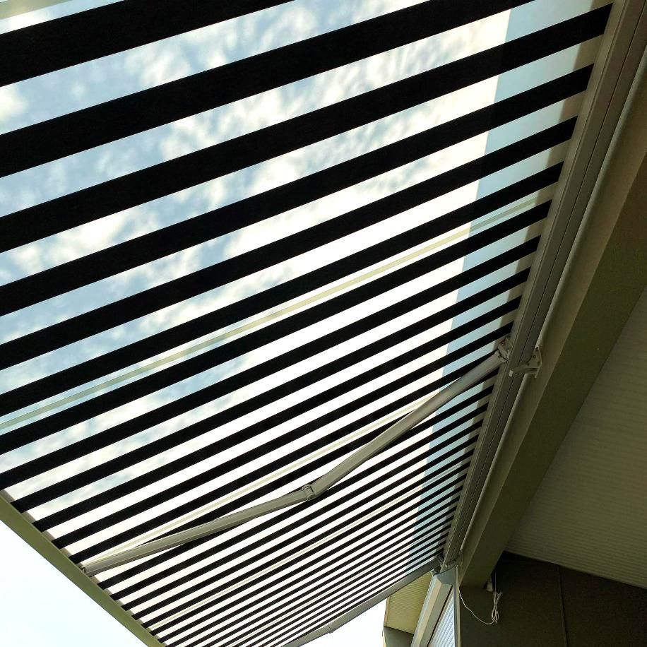 Black And White Striped Awning Partially Extended — JSF Interiors Goulburn in Bowral, NSW