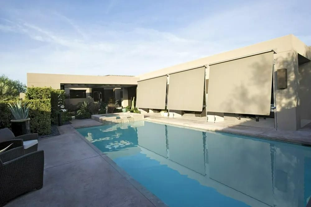 Modern Home Poolside With Closed Neutral Shades And Wicker Furniture — JSF Interiors Goulburn in Goulburn, NSW