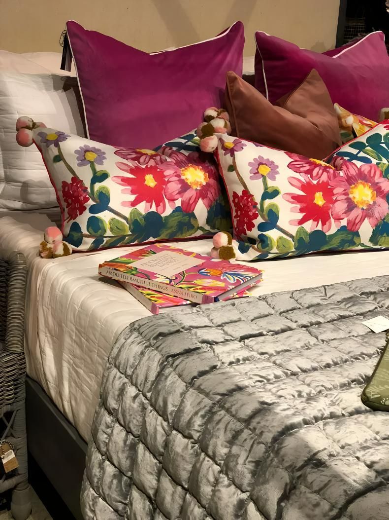 Bed With Floral Pillows And Gray Quilted Blanket — JSF Interiors Goulburn in Goulburn, NSW