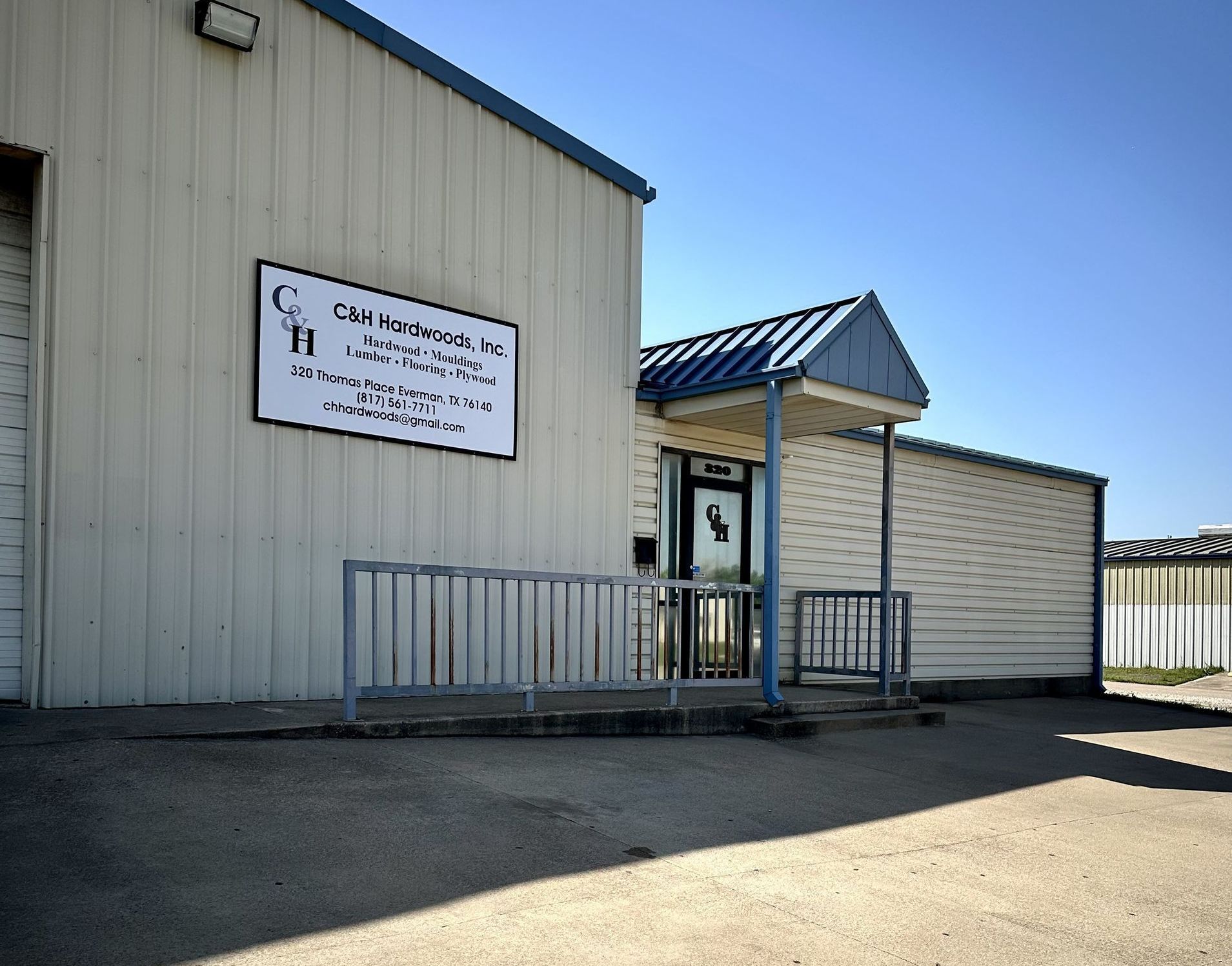 Exterior of a light industrial building with a sign for 