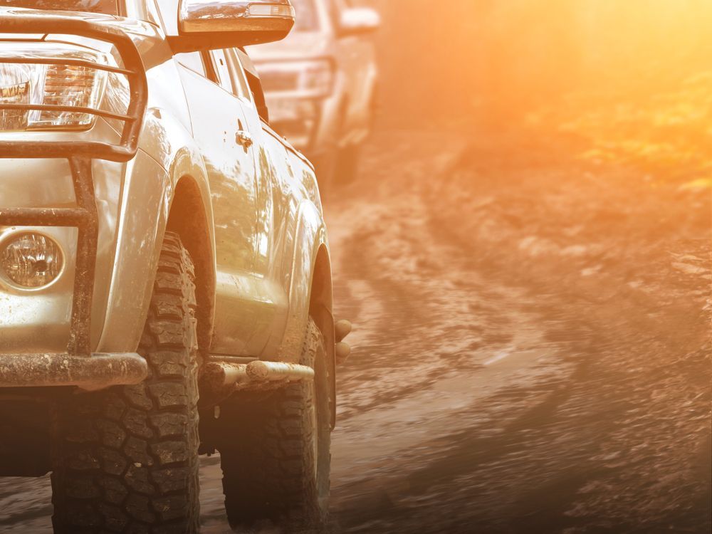 Off-road Vehicles Driving on a Muddy, Dirt Path — Mid Coast Smash Repairs In Tuncurry, NSW