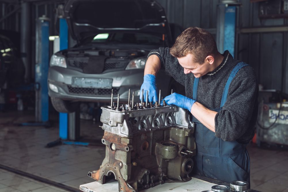 Mechanic Working on an Engine in a Garage — Mid Coast Smash Repairs In Forster, NSW