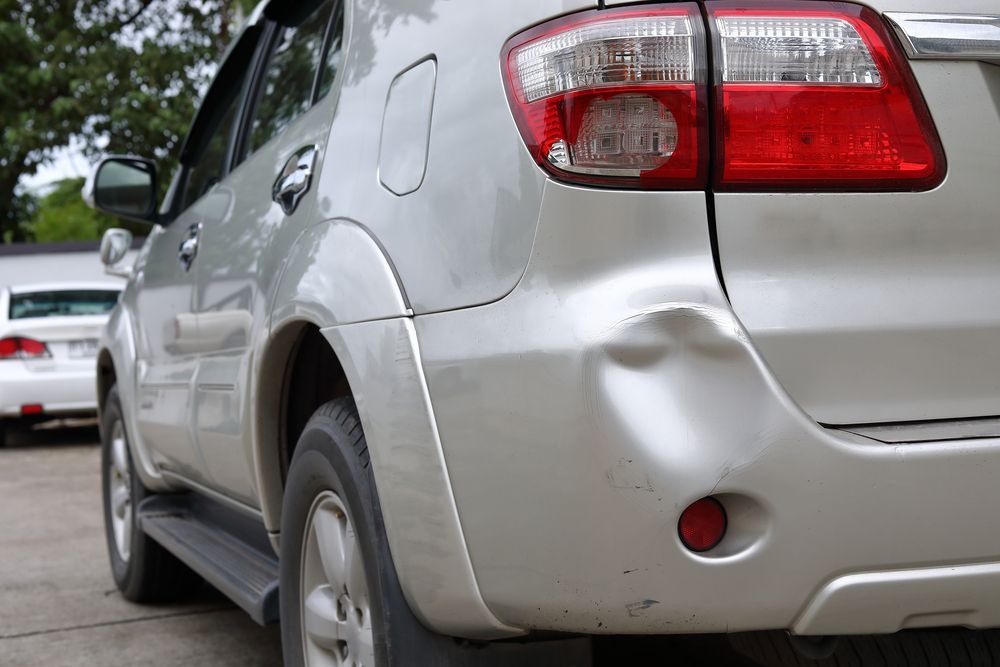 Silver Suv With a Dent in the Rear Quarter Panel — Mid Coast Smash Repairs In Mid North Coast, NSW