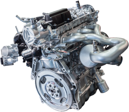 Car engine, metallic, visible components, exhaust manifold, flywheel.