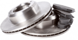 Two shiny, slotted brake rotors with a stack of brake pads.