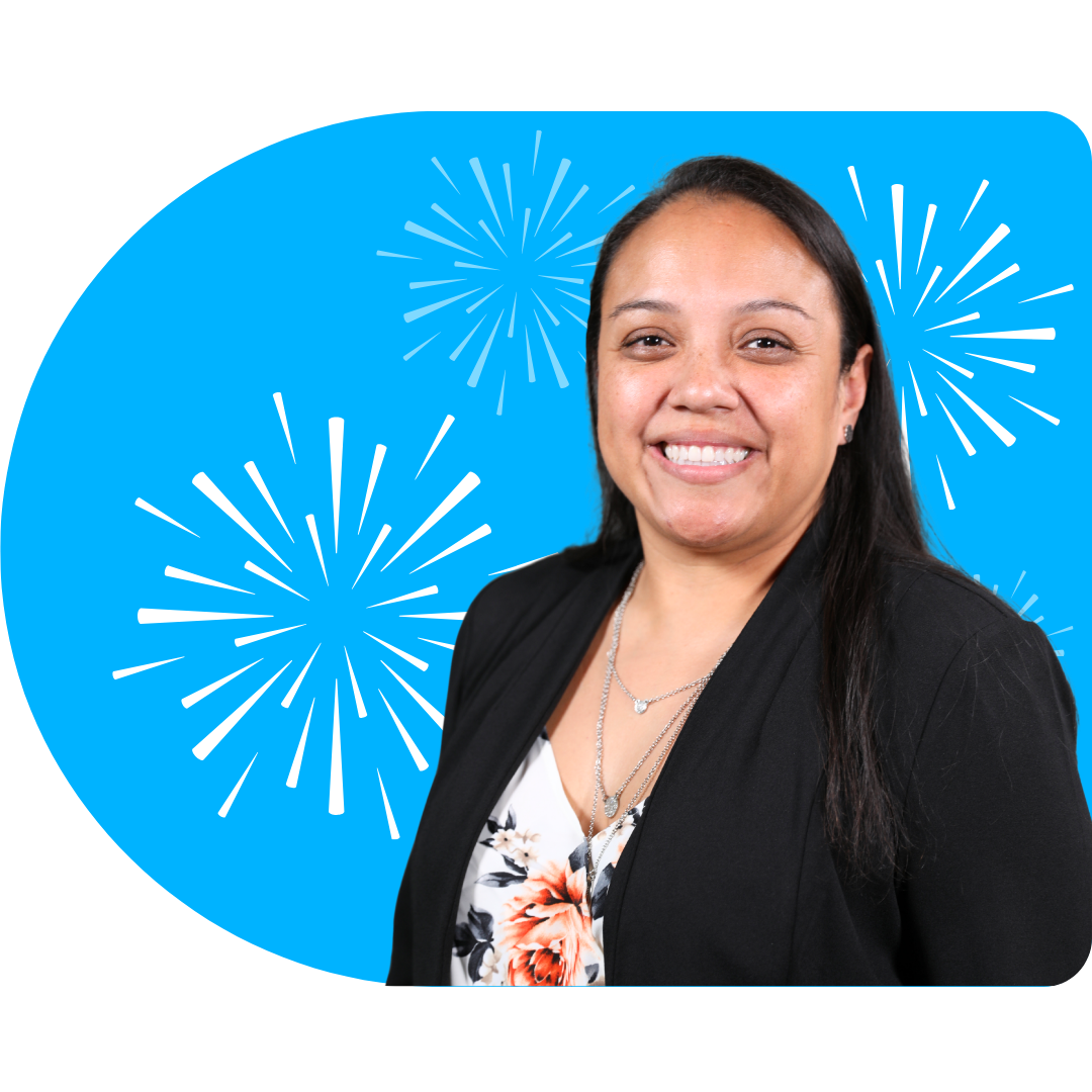 A person with blonde highlights, wearing a black blazer and necklace, posing against a blue background with white fireworks.