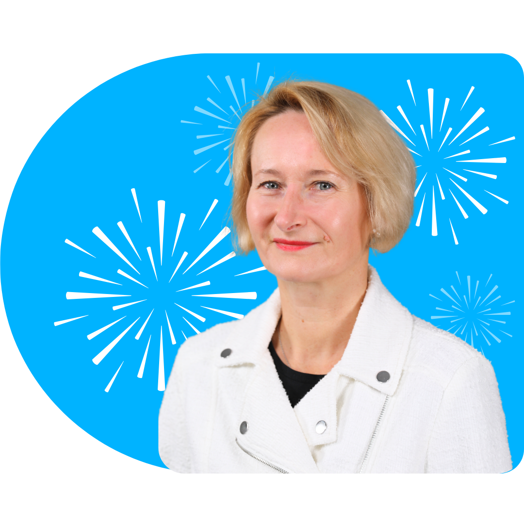A person smiling, wearing a white blazer against a bright blue background featuring white, stylized firework illustrations.