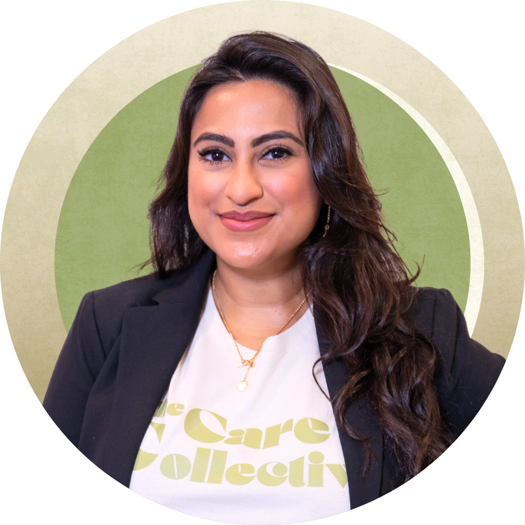 A woman with long dark hair wearing a blazer over a 