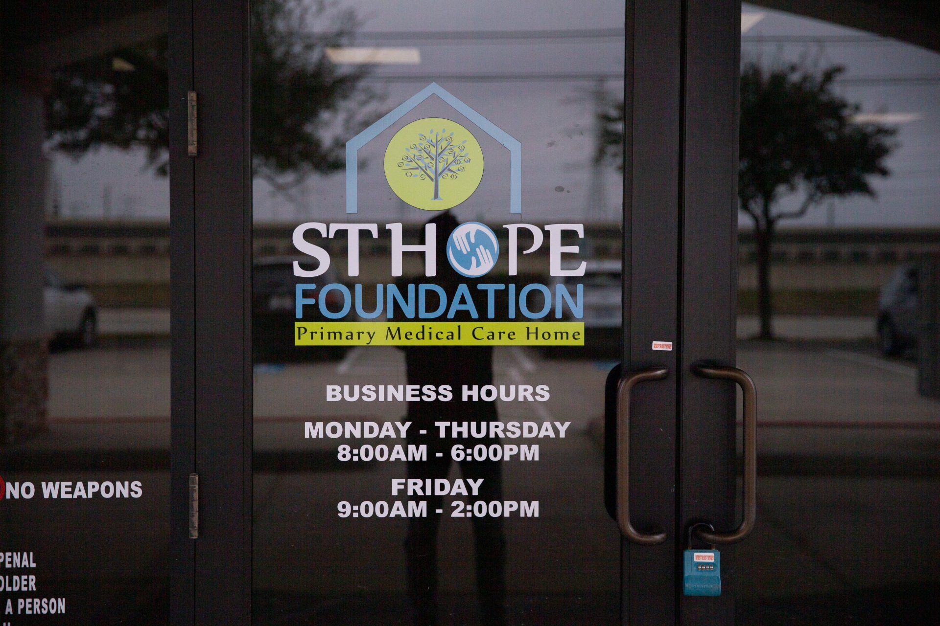 The STHOPE Foundation storefront door with business hours listed: Monday-Thursday 8am-5pm and Friday 9am-2pm.