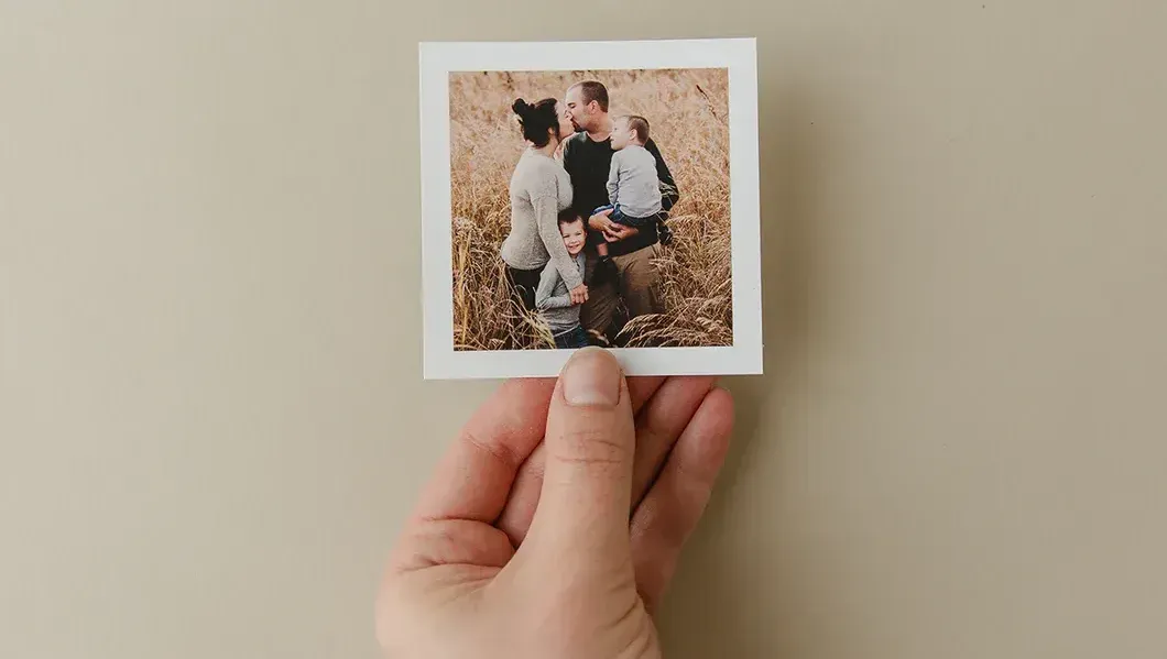 close-up of a hand holding up a 3.5 x 3.5 printed image