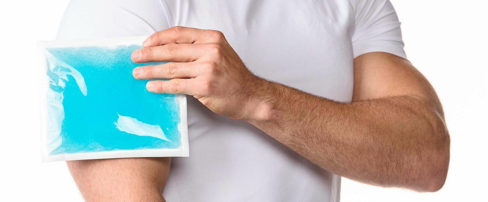 a person applying an ice pack on his arm a person applying an ice pack on his arm