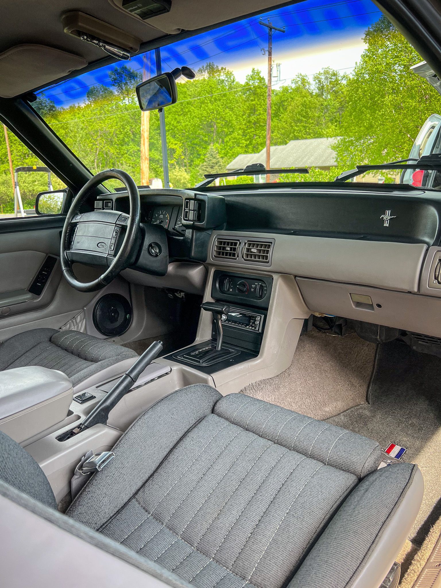 The interior of a ford mustang with a steering wheel and dashboard.