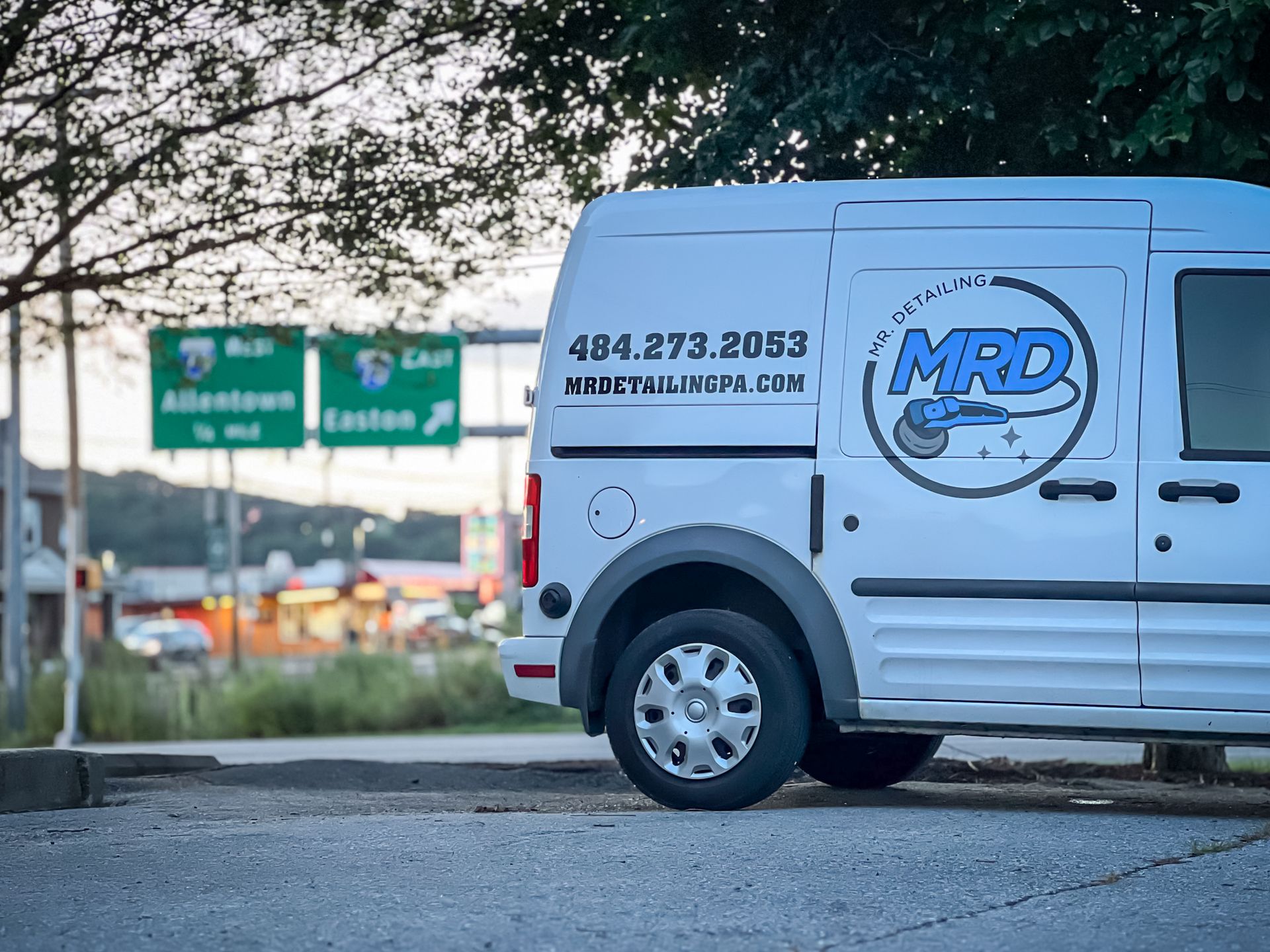 A white mrd van is parked in a parking lot