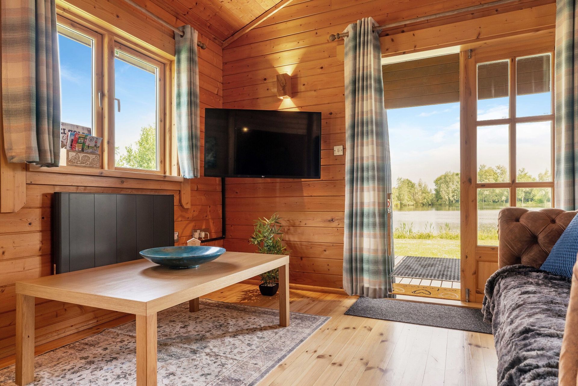 Lakeside living room with doors opening onto the veranda