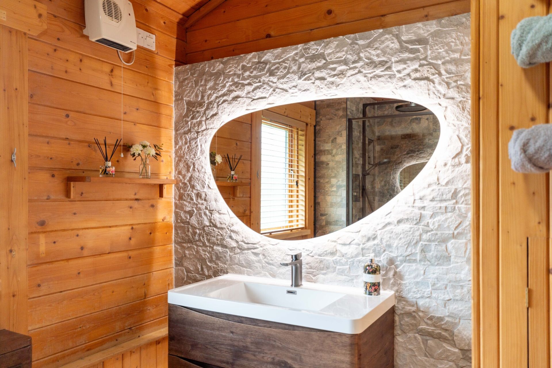 Bathroom with pebble mirror and walk-in shower at Lodge 5 Heron