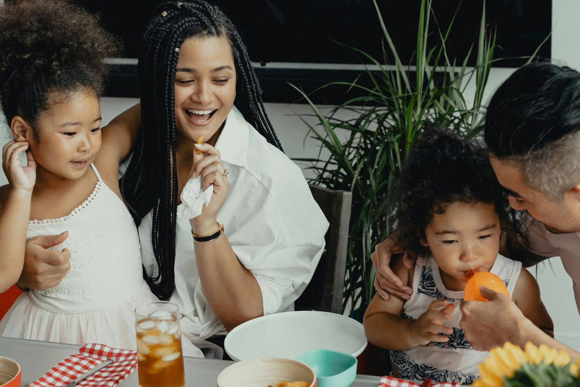 A family is sitting at a table eating food.