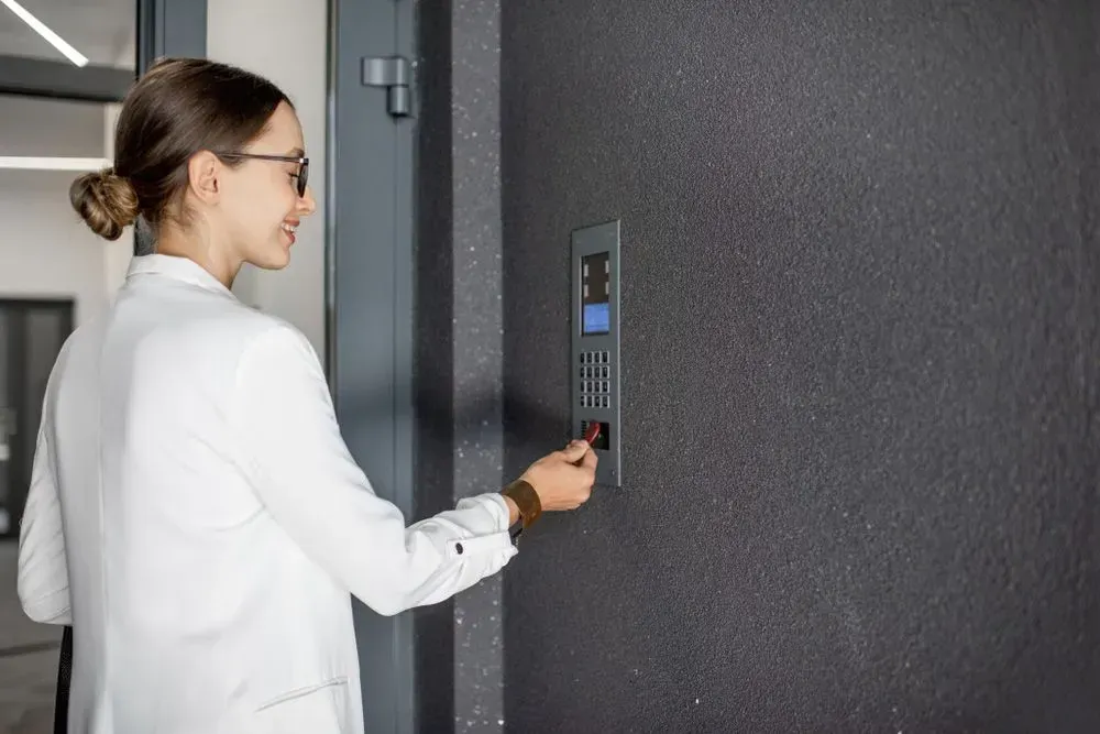A Woman Is Using a Key to Open a Door — Lock & Door in Wodonga, VIC