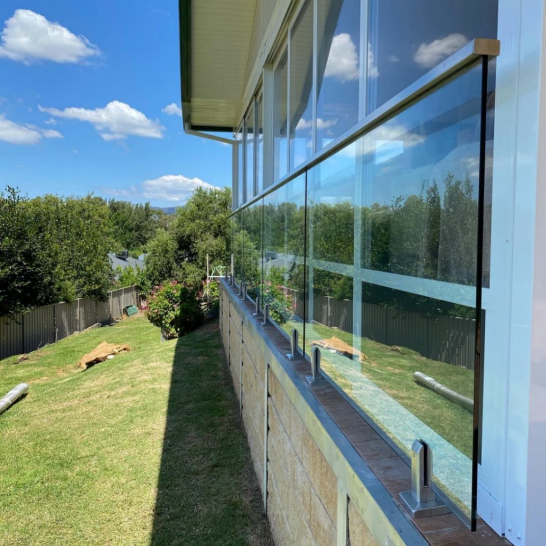 A House with A Glass Railing on The Side of It — Lock & Door in Wodonga, VIC