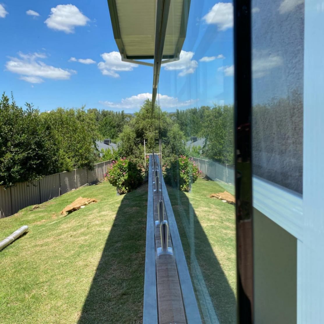 A View of A Lush Green Field from A Balcony — Lock & Door in Wodonga, VIC