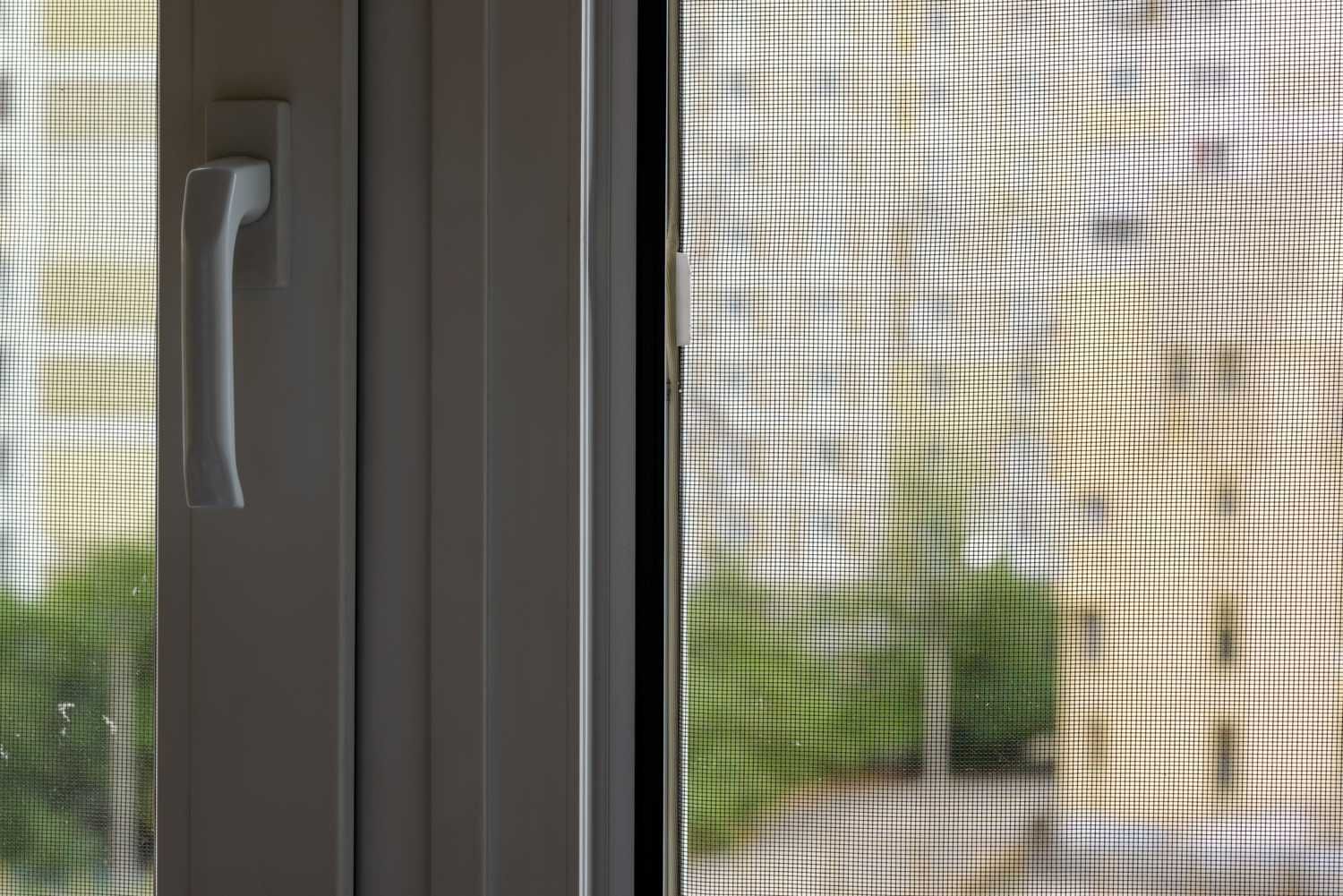 A Close up Of a Mosquito Screen on A Window — Lock & Door in Wodonga, VIC