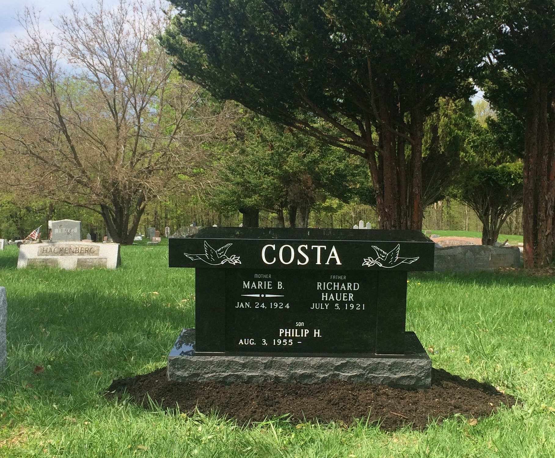 A black granite headstone with the name 