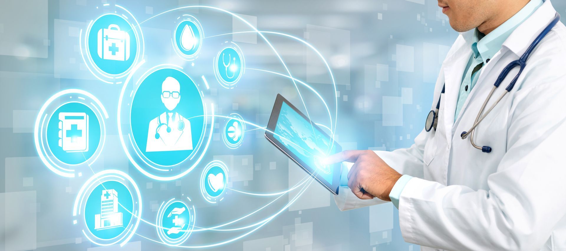 A doctor is using a tablet computer with a stethoscope around his neck.