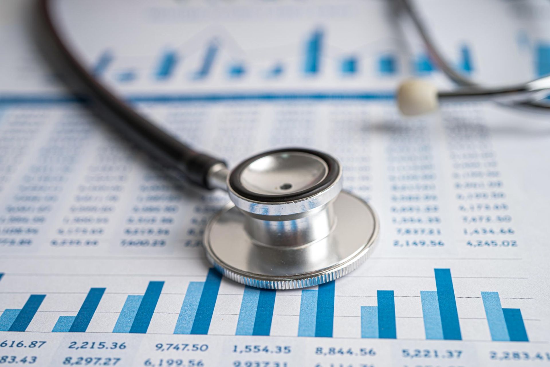 A stethoscope is sitting on top of a graph.