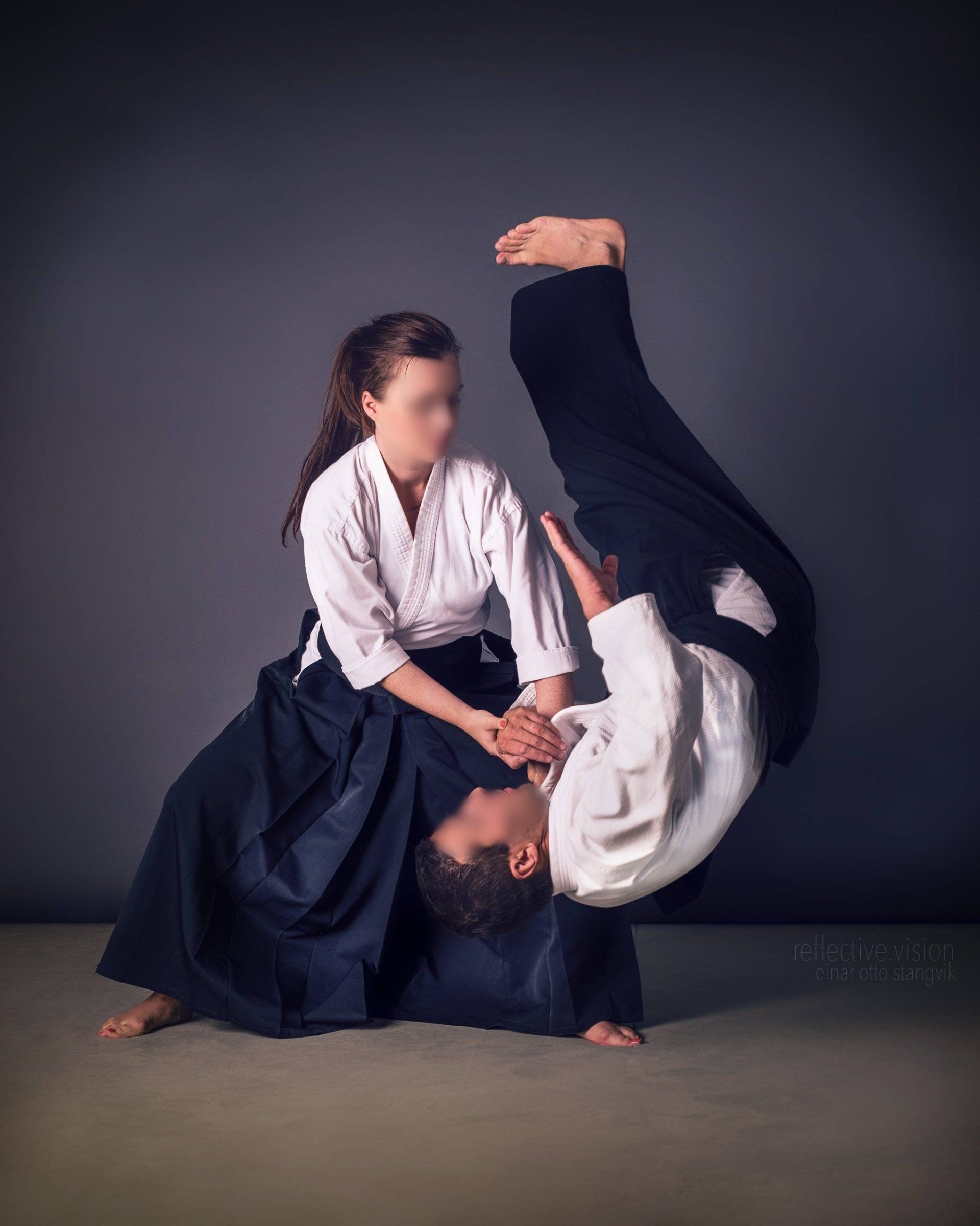 Aikido practitioner performing a throw on a training partner
