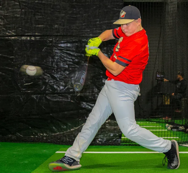 Someone hitting in the HitTrax Tunnel