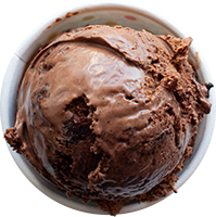 Scoop of pinkish-red ice cream in a white bowl, slightly melted, close-up.