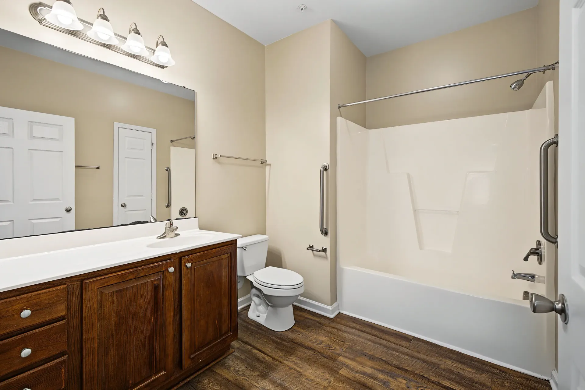 Bathroom with vanity, toilet, and shower/tub combo.