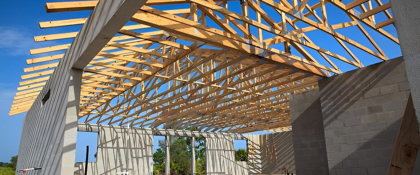 The Roof of A Building Is Being Built With Wooden Beams — Smithys Crane Hire in Trinity Beach, QLD