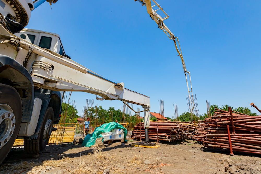A Concrete Pump Truck is Pouring Concrete on a Construction Site — Smithys Crane Hire in Gordonvale, QLD