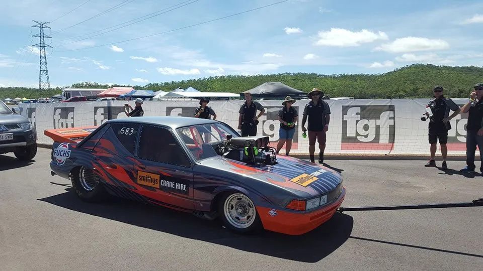 A Race Car Is Parked On The Side Of The Road — Smithys Crane Hire in Trinity Beach, QLD
