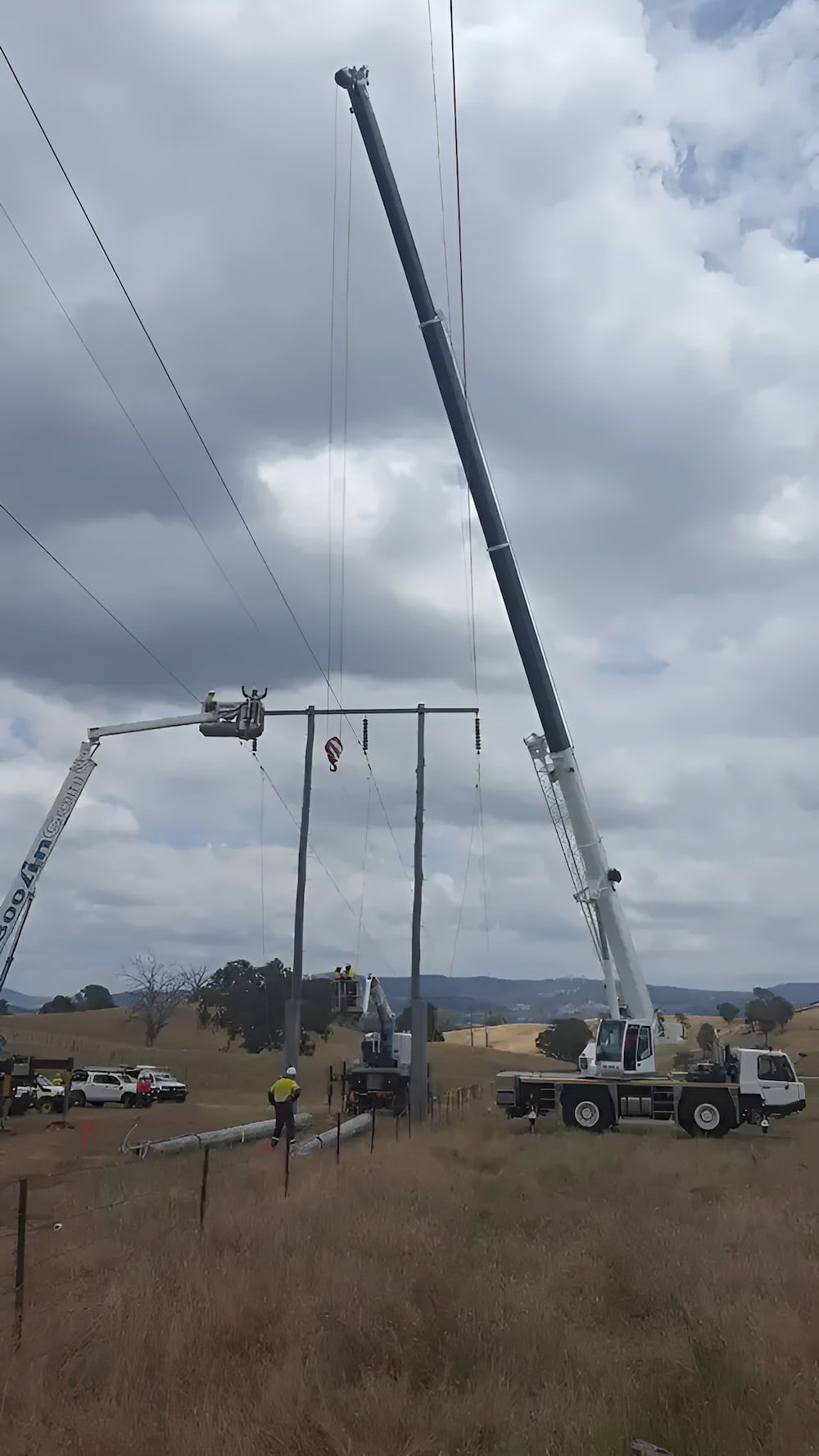 A Crane is Working on a Power Line in a Field — Smithys Crane Hire in Edge Hill, QLD