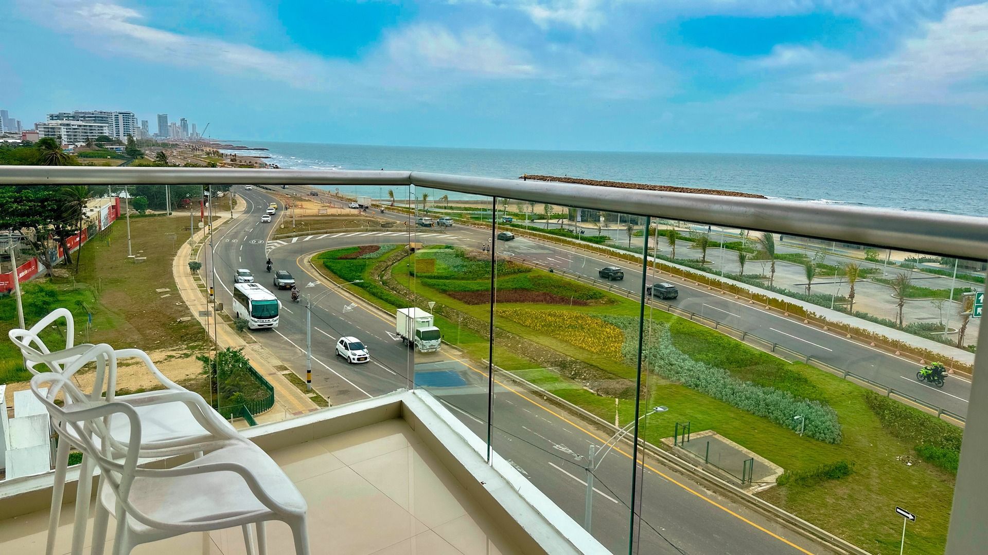 Un balcón con dos sillas y vista al mar.