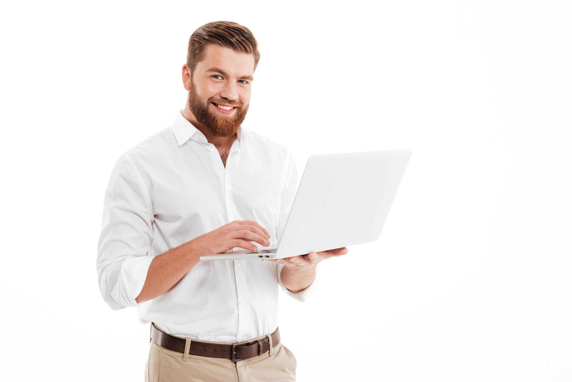 A man with a beard is using a laptop computer.