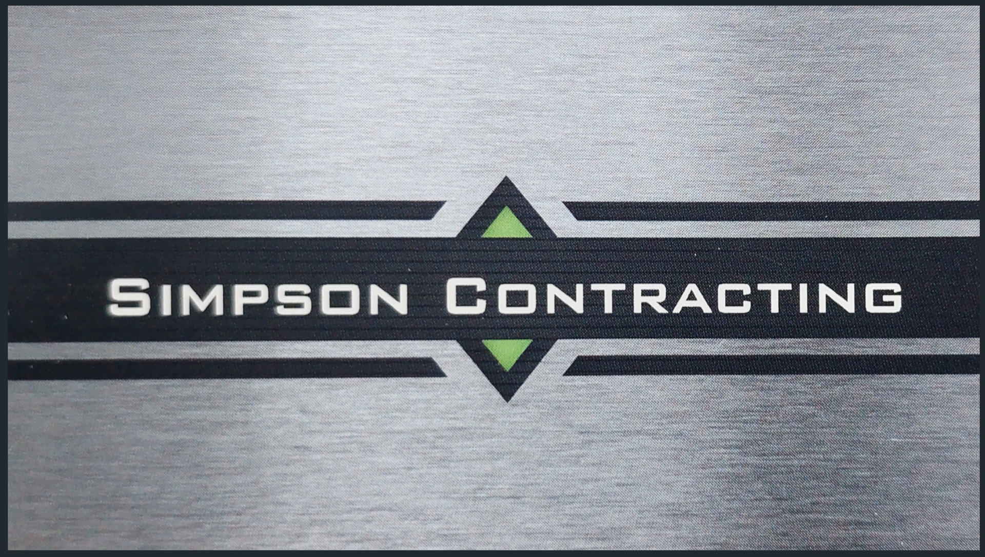 A business card for simpson contracting is shown