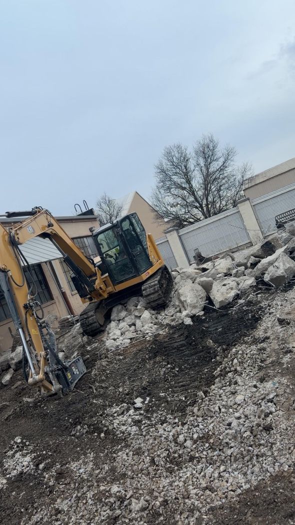 Bulldozer on a snowy construction site with piles of dirt and a cloudy sky Bulldozer on a snowy construction site with piles of dirt and a cloudy sky