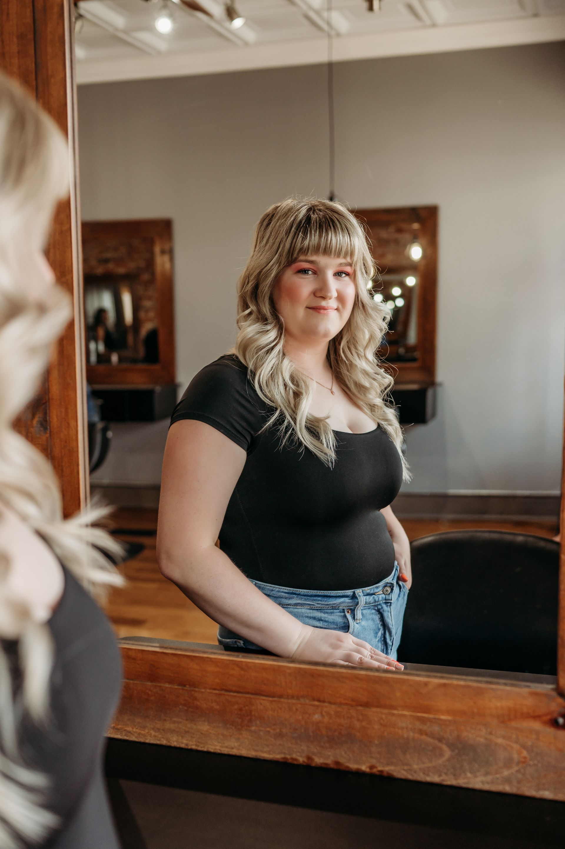 hair stylist giving highlights to woman